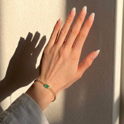 Curb chain bracelet with emerald-cut Emerald